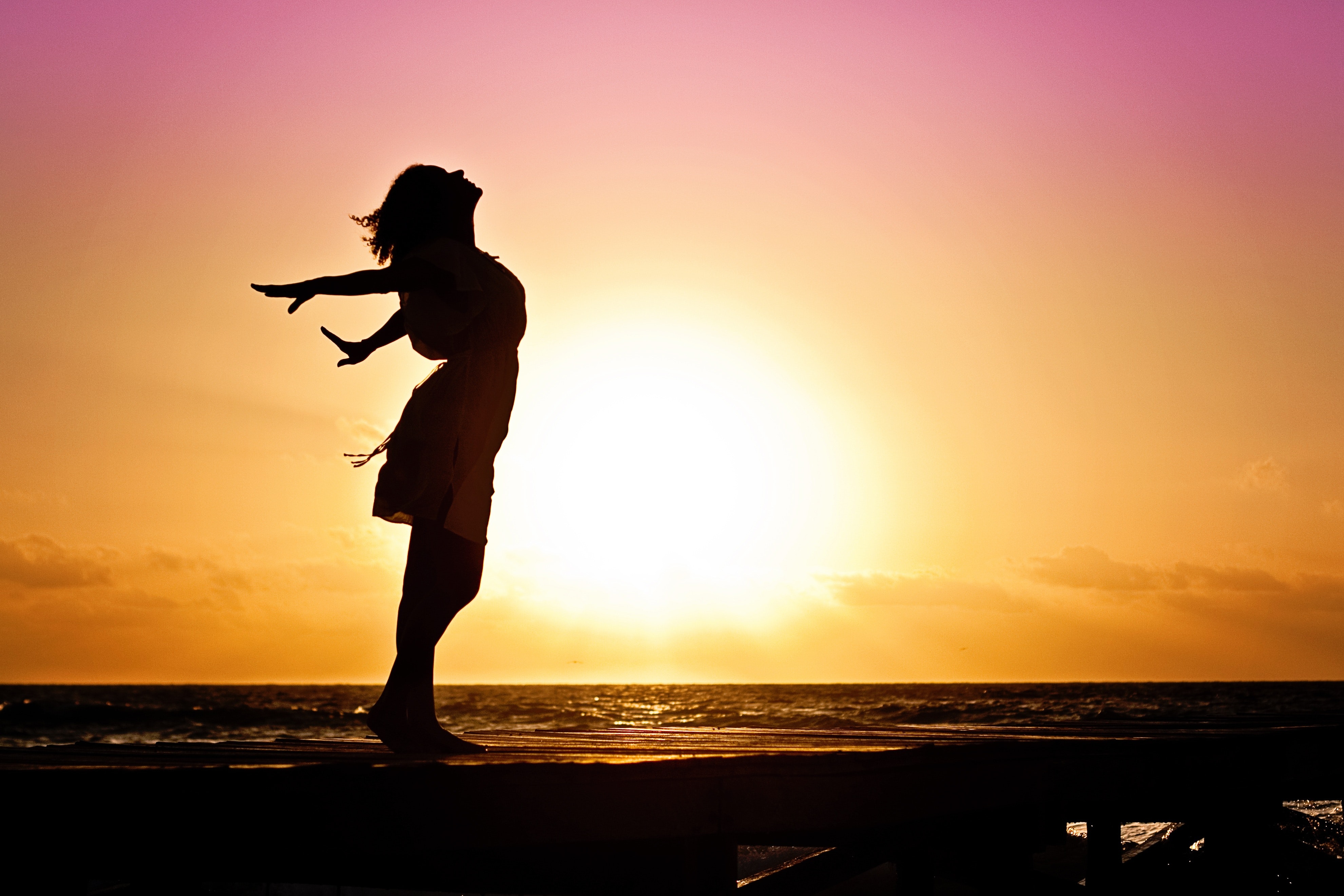 Woman stretching before sunset